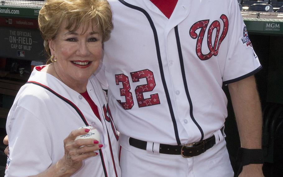 Former Sen. Elizabeth Dole, the head of a foundation that supports military caregivers, poses with Washington Nationals catcher Matt Wieters before a game between the Washington Nationals and Boston Red Sox in Washington, D.C., July 4, 2018.