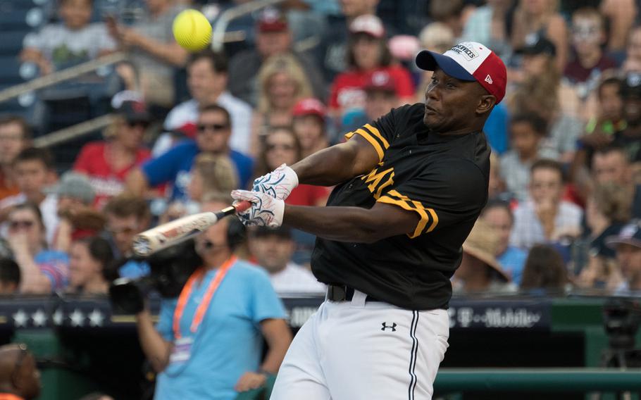 U.S. Army Sgt. Maj. John Horner makes contact with a pitch during the 2018 Armed Forces Classic, a co-ed softball game held at Nationals Park in Washington on Friday, July 13, 2018.