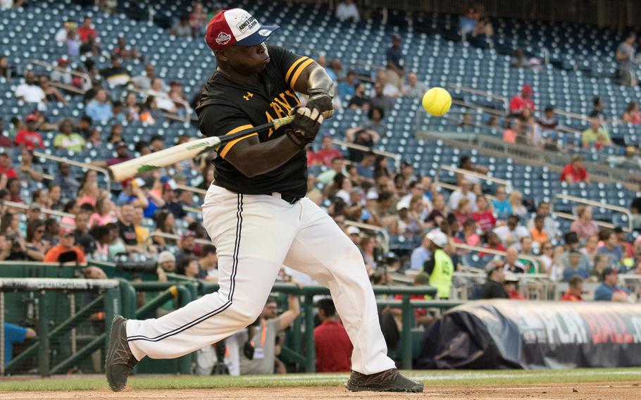 Chief Warrant Officer 3  Richard Moreland swings at a pitch during the 2018 Armed Forces Classic, a co-ed softball game held at Nationals Park in Washington on Friday, July 13, 2018.