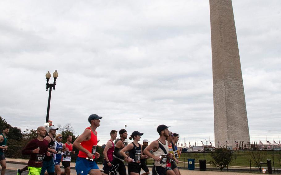 Runners in the 43rd Marine Corps Marathon pass the Washington Monument in Washington, D.C., Oct. 28, 2018.
