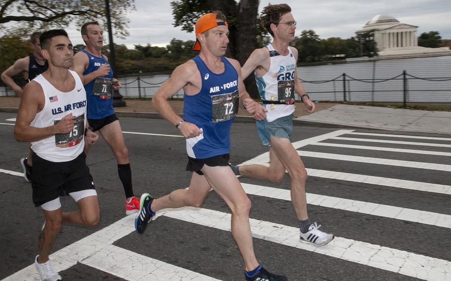 Air Force runners Jacob McCubbin (75) and Timothy Richard (72) lead a pack past the Jefferson Memorial during the 43rd Marine Corps Marathon in Washington, D.C., Oct. 28, 2018.