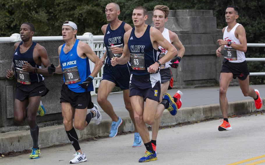 Runners in a pack at the 11.5-mile mark of the 43rd Marine Corps Marathon in Washington, D.C., Oct. 28, 2018, include Will Christian (60), Patrick Hearn (61) and Jordan Tropf (63) of Navy and Kristopher Houghton (70) of Air Force. Hearn finished second in te race, with Christian third, Tropf sixth and Houghton 12th.