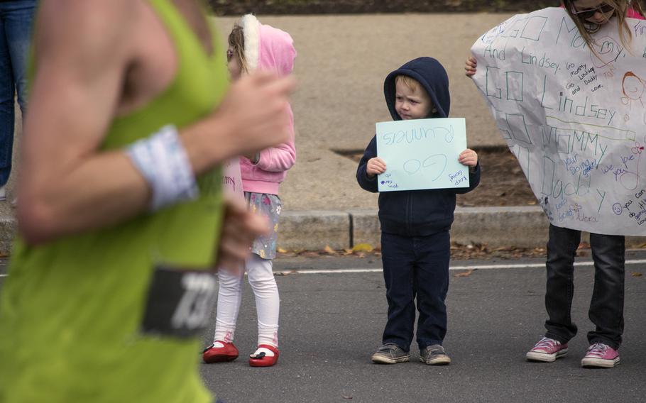 A young boy holds his sign upside down on the sidelines of the 43rd Marine Corps Marathon on Oct. 28, 2018.