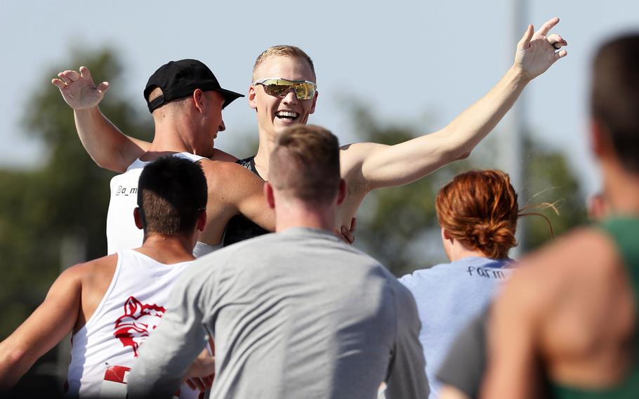 Sam Kendricks, center, celebrates with fellow competitors after setting an American record in the pole vault at the U.S. track and field championships on Saturday, July 27, 2019, in Des Moines, Iowa. 