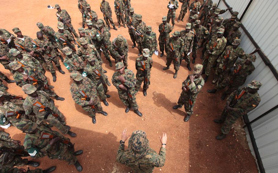 A Marine goes over threat detection methods with a group of Ugandan soldiers in this Feb. 2012 photo. A small team of Marines were sent to Uganda to train Ugandan forces for the fight against al-Shabaab in Somalia and the hunt for Joseph Kony and the Lord’s Resistance Army.