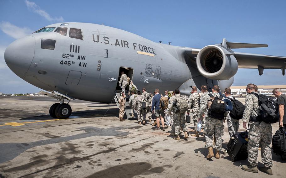 A group of 30 U.S. military personnel, including Marines, Airmen, and Soldiers from the 101st Airborne Division, board a U.S. Air Force C-17 Globemaster III at Leopold Sedar Senghor International Airport in Dakar, Senegal, Oct. 19, 2014. The service members are bound for Monrovia, Liberia, where U.S. troops will construct medical treatment units and train health care workers as part of Operation United Assistance, the U.S. Agency for International Development-led, whole-of-government effort to respond to the Ebola outbreak in West Africa. 