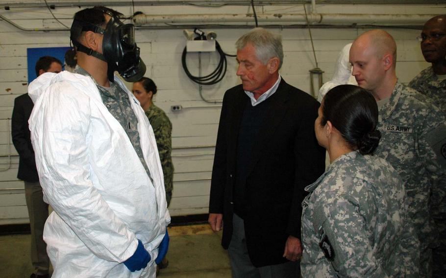 Secretary of Defense Chuck Hagel, middle, greets a soldier Monday, Nov. 17, 2014, at Fort Campbell, Ky., who is training for the Ebola response mission in West Africa.