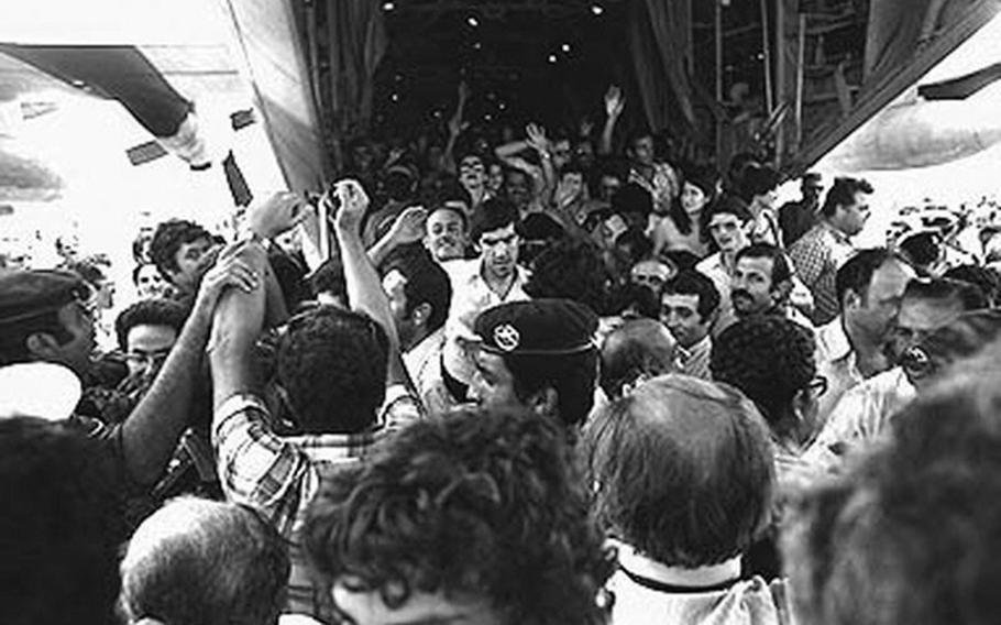 In a July 4, 1976 file photo, former hostages come home after the successful Israeli raid on the airport at Entebbe, Uganda.