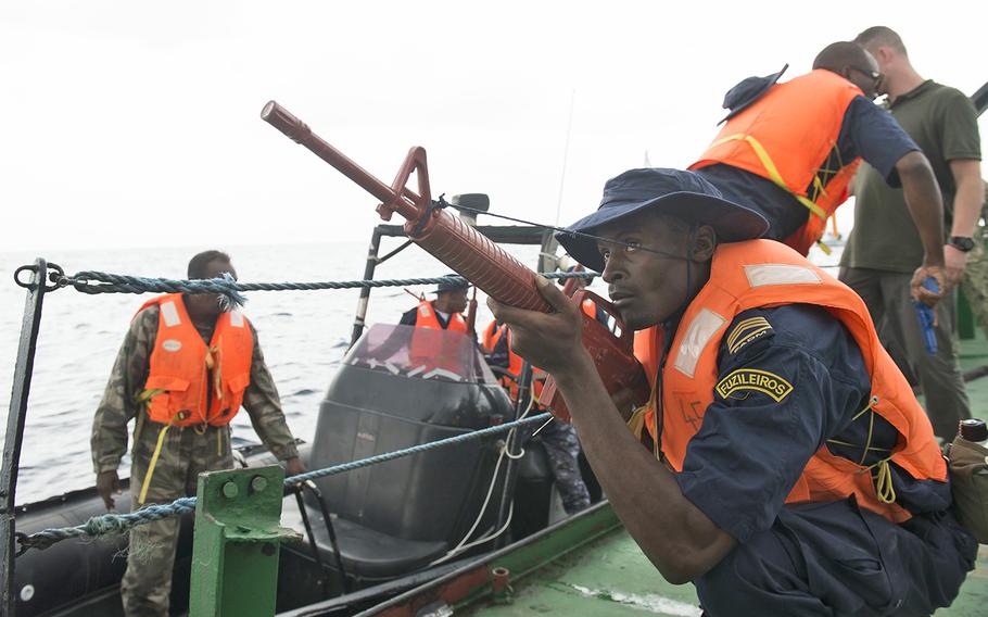 A Mozambique Marine boards the Djibouti Coast Guard tugboat Bourhan Ali Warki during Exercise Cutlass Express 2017 in the Gulf of Aden, Feb. 4, 2017. The exercise, sponsored by U.S. Africa Command and conducted by U.S. Naval Forces Africa, is designed in part to combat piracy in the AFRICOM area of responsibility. 