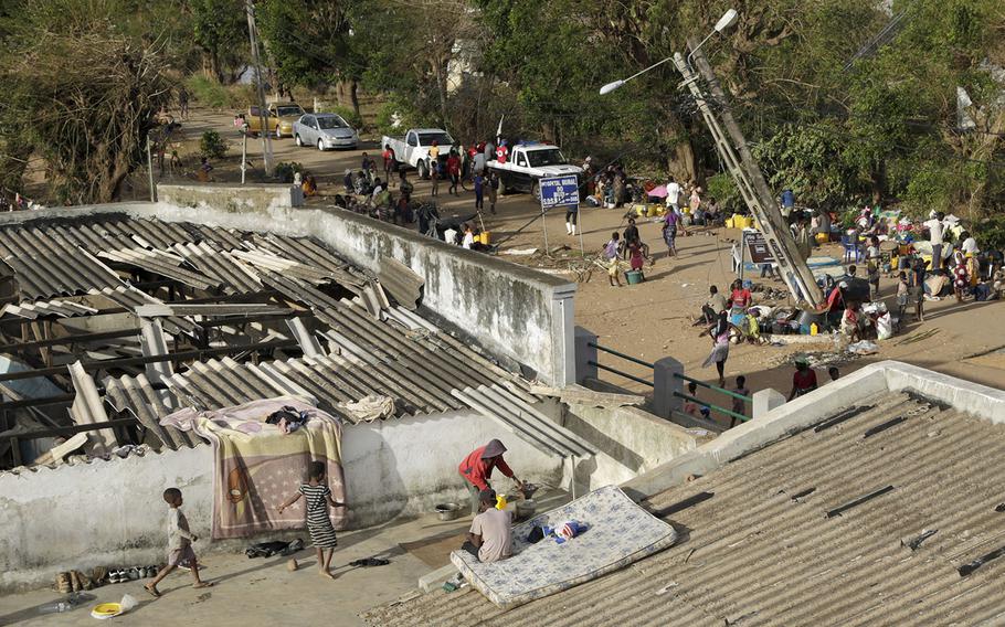 Displaced families set up their bedding on top of the roof in Buzi district, 120 miles outside Beira, Mozambique, on Saturday, March 23, 2019.