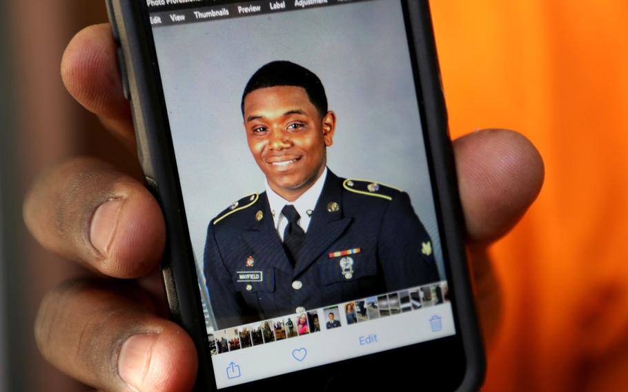 Henry Mayfield holds a picture of his son, Army Spc. Henry Mayfield Jr., who was killed in an attack on a military base in Kenya.