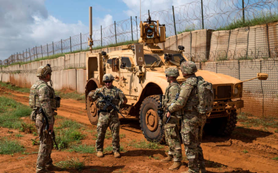 U.S. Army soldiers discuss security operations during a  patrol in Somalia in December 2019. A White House plan to reduce forces in conflict zones includes removing all 700 troops in Somalia, according to media reports.