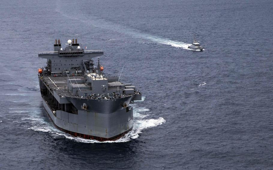 The Expeditionary Sea Base USS Hershel ''Woody'' Williams conducts a passing exercise with a Senegalese navy patrol vessel in the Atlantic Ocean off the west coast of Africa in September 2020. The ship is now off the east African coast in an operation to remove U.S. forces from Somalia.