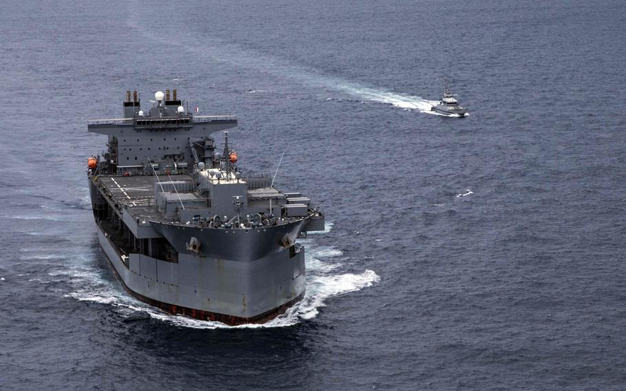 The Expeditionary Sea Base USS Hershel ''Woody'' Williams  conducts a passing exercise with a Senegalese navy patrol vessel in the Atlantic Ocean off the west coast of Africa in September 2020. The ship is now off the east African coast in an operation to remove U.S. forces from Somalia.