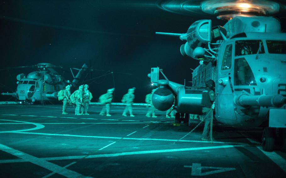 U.S. Marines and sailors with the 15th Marine Expeditionary Unit board a CH-53E Super Stallion during a quick reaction force drill aboard the USS San Diego,  in support of Operation Octave Quartz in the Indian Ocean off the coast of Somalia, Dec. 20, 2020. 
