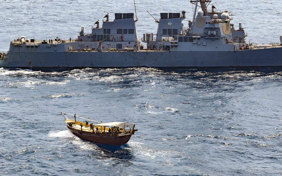 Service members from the destroyer USS Winston S. Churchill board a stateless dhow off the coast of Somalia on Feb. 12, 2021. 