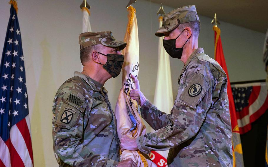 U.S. Army Gen. Stephen J. Townsend, commander of U.S. Africa Command, hands the Combined Joint Task Force - Horn of Africa flag to U.S. Army Maj. Gen. William L. Zana during a ceremony at Camp Lemonnier, Djibouti, May 15, 2021.

