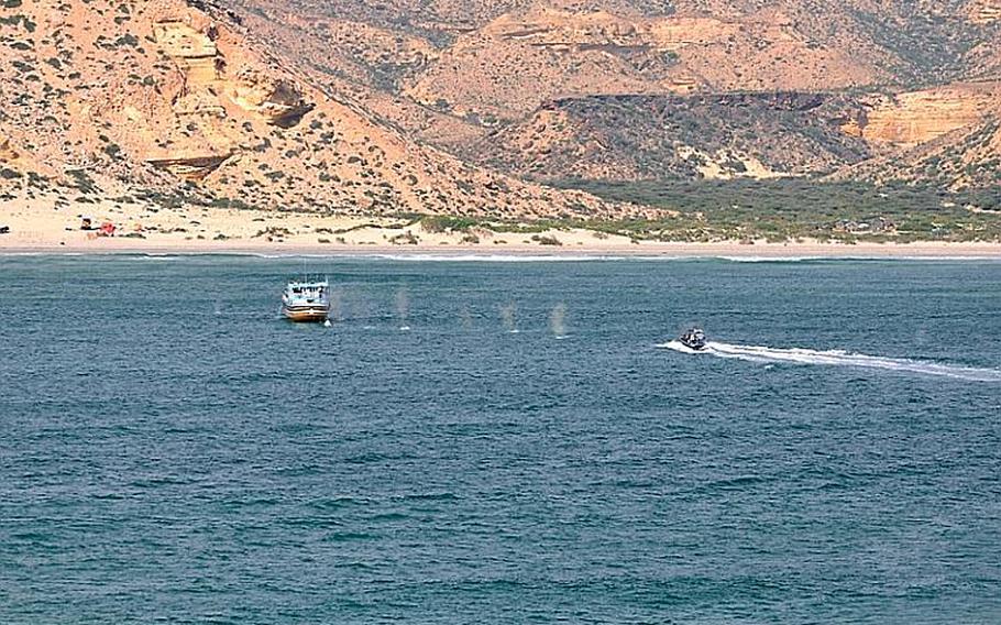 Small boat from the HNLMS Rotterdam returning fire on a suspect Dhow after coming under fire during an approach off the coast of Somalia on Oct. 24, 2012. The Rotterdam came under fire from groups of suspected pirates from shore and from the sea.
