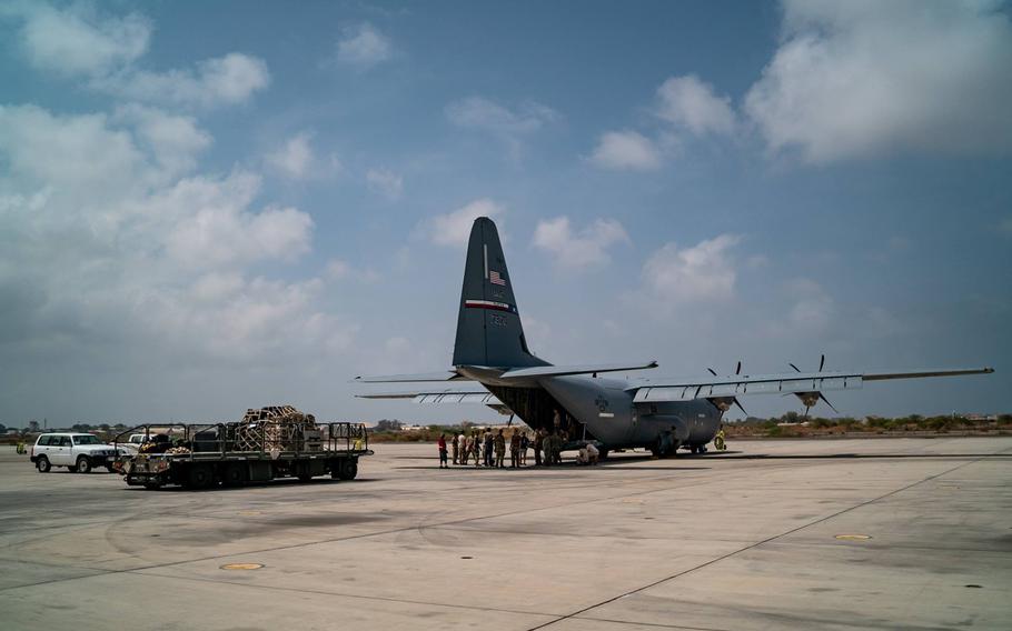 A U.S. Air Force C-130 sits on the tarmac as U.S. airmen deploy to Mozambique to deliver relief supplies into areas where floods have forced thousands from their homes.