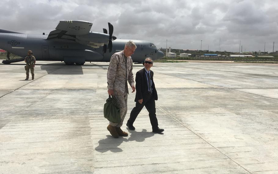 Marine Gen. Thomas Waldhauser, head of U.S. Africa Command, and U.S. Ambassador to Somalia Donald Yamamoto talk on the tarmac at the Aden Adde International Airport in Mogadishu, Somalia on Tuesday, June 11, 2019, on the way to a meeting with Somalia Prime Minister Hassan Ali Khaire and defense leaders.