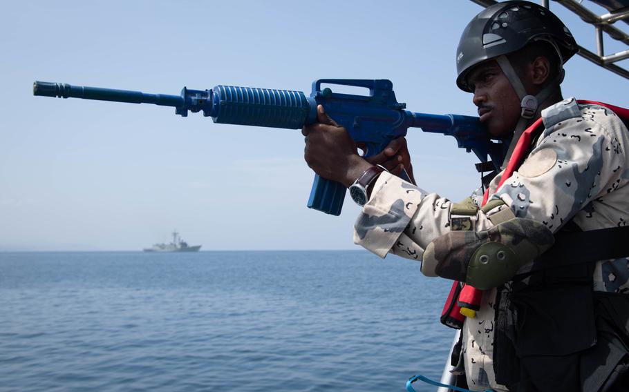 A Djiboutian coast guardsman participates in a visit, board, search and seizure exercise during Cutlass Express and the International Maritime Exercise off the coast of Djibouti, Africa, Nov. 3, 2019.