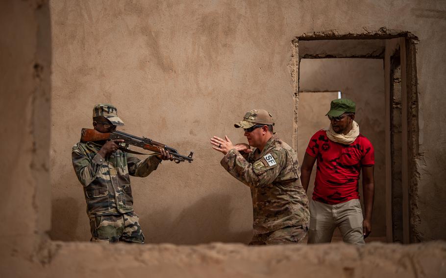 Tech. Sgt. Tyler Torr, center, an air adviser with the 409th Expeditionary Security Forces Squadron, gives instructions to a Niger armed forces soldier during a training exercise on Nigerien Air Base 201 in Agadez, Niger, July 10, 2019, as a translator, right, interprets. 