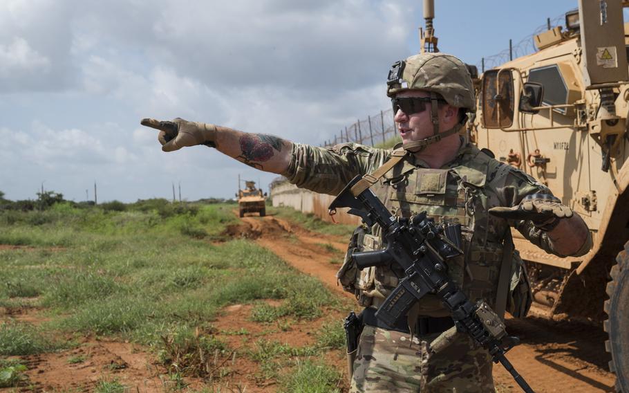 U.S. Army Sgt. Don Baldwin, 1-186th Infantry Battalion, Oregon National Guard, points to the horizon while explaining items of interest to look out for during a security patrol in Somalia, on December 3, 2019.