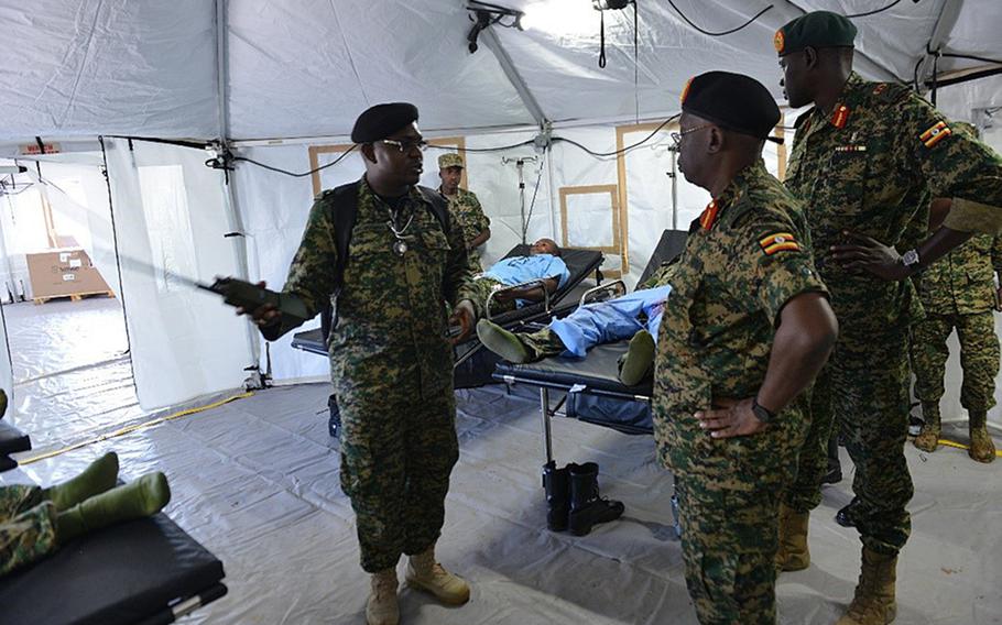 Ugandan soldier 1st Lt. Vincent Nzayisenga, a medical clinic officer, discusses the layout of a mobile treatment facility, May 15, 2019, in Jinja, Uganda. The U.S. has delivered mobile hospitals to Uganda and two other African nations. The units are now being used to treat coronavirus patients.