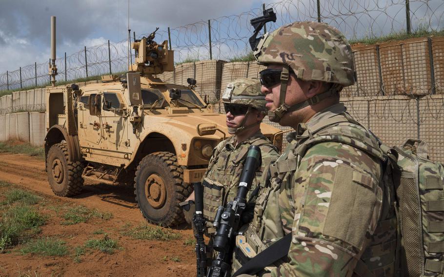 U.S. Army Spc. Cristobal Orozco and Spc. Robert Fisher of the Oregon National Guard listen to their patrol leader's instructions in Somalia in December 2019. President Donald Trump has reportedly told advisers that he wants to withdraw U.S. troops from the African country.