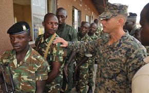 U.S. Marine Corps Sgt. Ibrahim Bosch talks to a Burundi National Defense Force (BNDF) soldier before he clears a building during a training exercise in Bujumbura, Burundi, March 19, 2014. Bosch and the rest of the SP-MAGTF AF have been working with the BNDF during a 10-week logistics training course to prepare BNDF soldiers for deployments to Somalia and the Central African Republic. The deployments are in support of the African Union Mission in Somalia and the African-led International Support Mission in the Central African Republic. 
