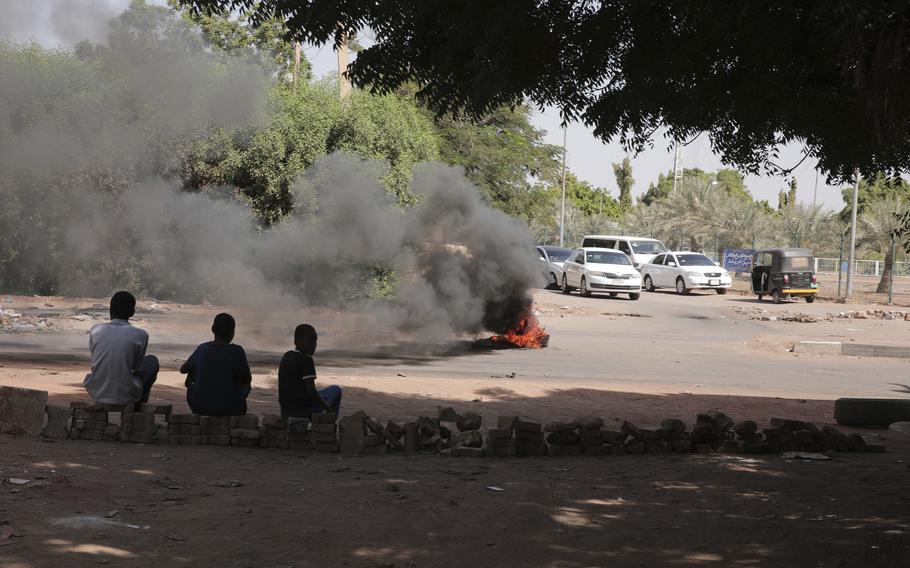 People burn tires in Khartoum, Sudan, Sunday, Nov. 7, 2021. Sudan's protest movement has rejected internationally backed initiatives to return to a power-sharing arrangement with the military after last month's coup.