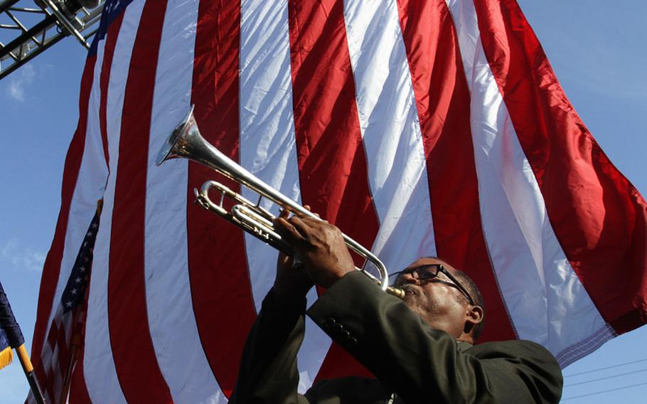 High School band director Otis Carter III plays 'Taps' during a ceremony at Moss Point, Mississippi Central Fire Station on Tuesday, September 11, 2012, commemorating the Sept. 11, 2001 terrorist attacks. 