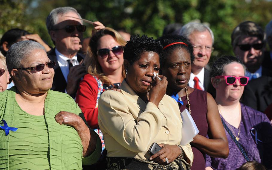 Survivors from the Sept. 11 attacks react during President Barack Obama's speech as he commemorates the 11th anniversary of the 9/11 attacks during a ceremony at the Pentagon, Tuesday, September 11, 2012, in Arlington, Virginia. 