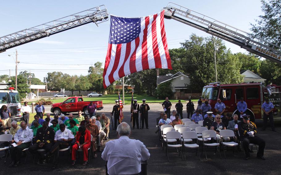 The Rev. David Greer says a prayer of unity during a ceremony at Moss Point, Mississippi, Central Fire Station on Tuesday, September 11, 2012, commemorating the Sept. 11, 2001 terrorist attacks.