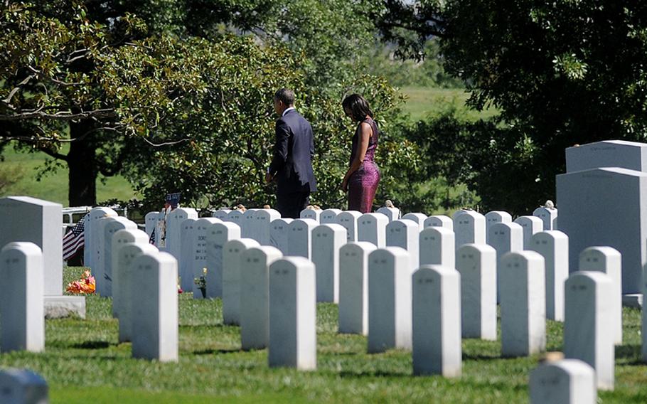 President Barack Obama and first lady Michelle Obama make a stop at the section 60 at Arlington Cemetery to commemorate the 11th anniversary of the 9/11 attacks during a ceremony at the Pentagon, Tuesday, September 11, 2012, in Arlington, Virginia.