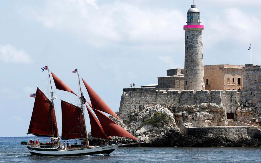 The Schooner Jolly II Rover of Key west sails into Havana Bay flying a Cuban, and a U.S. national flag, backdropped by the Morro Fortress lighthouse, in Havana, Cuba, Wednesday, May 20, 2015. Competitive sailors from the U.S. and Cuba have been showing off their skills in Havana Bay as the two countries work on restoring diplomatic relations after decades of hostility.