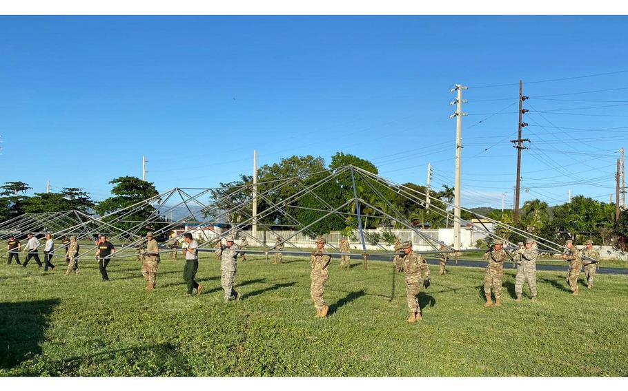 Puerto Rico National Guard members on Jan. 11, 2020, build a tent to shelter people in Guanica following a series of devastating earthquakes in the southern region of the island. About 650 service members were activated to help with five camps in cities most heavily impacted by earthquakes.