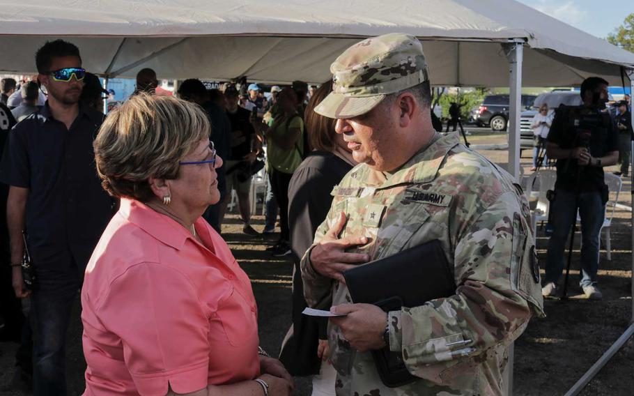Brig. Gen. Miguel Mendez, the commander of the military's earthquake response mission, speaks with Maria "Mayita" Melendez, mayor of Ponce, during a visit to shelter that National Guard troops built in the city. It is one of five cities where troops are supporting shelters for people who displaced by earthquakes that have shaken the island for the past month.