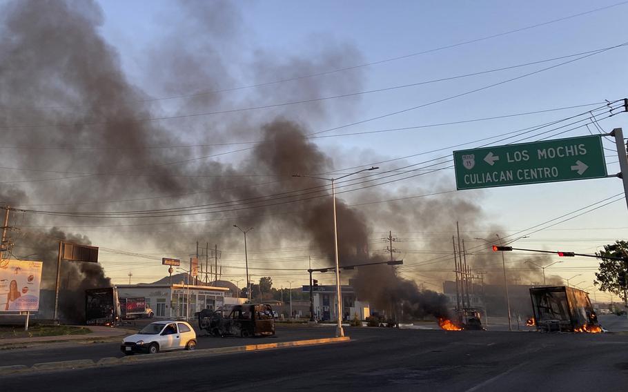 Burning vehicles are seen in the street during an operation to arrest the son of Joaquin "El Chapo" Guzman, Ovidio Guzman, in Culiacan, Sinaloa state, Mexico, on Thursday, Jan. 5, 2023. 