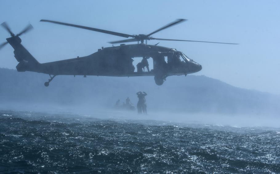 Members of the Army's 7th Special Forces Group practice helocasting from a Black Hawk helicopter with Salvadoran Special Forces soldiers at Lake Ilopango, El Salvador, March 7, 2019.