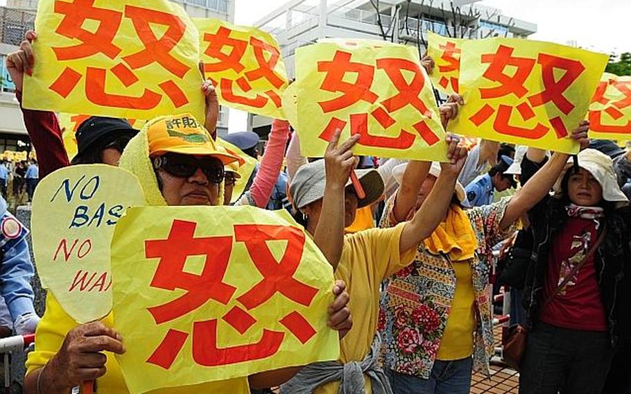 Protesters express anti-base sentiments while then Prime Minister Yukio Hatoyama met with Okinawa lawmakers at prefectural office building in Naha in 2010. 