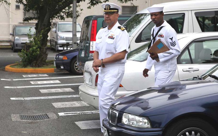 Navy Lt. Cmdr. Anthony Velasquez is escorted from the Yokosuka Naval Base court May 26, 2010, after being found guilty on two counts of wrongful sexual contact and two counts of conduct unbecoming an officer. 