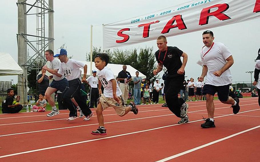 Athletes bolt from the starting line of the 400m race at the 2010 Kadena Special Olympics on Saturday. About 850 athletes competed in various events throughout the day.