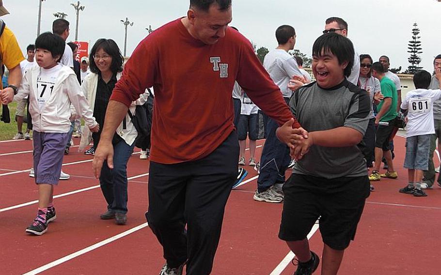 Marine Master Sgt. Raymundo Muro and his son, Sean, a 4th grader at Amelia Earhart Intermediate School, take part in a 30-meter race at Kadena Special Olympics Saturday at Kadena Air Base.