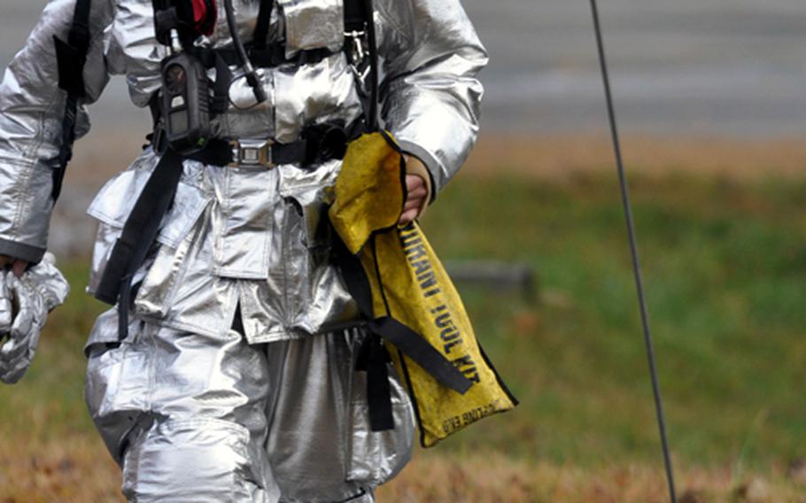 A base firefighter responds to the scene of a simulated accident and fuel truck spill Tuesday during a training exercise at Misawa Air Base, Japan.