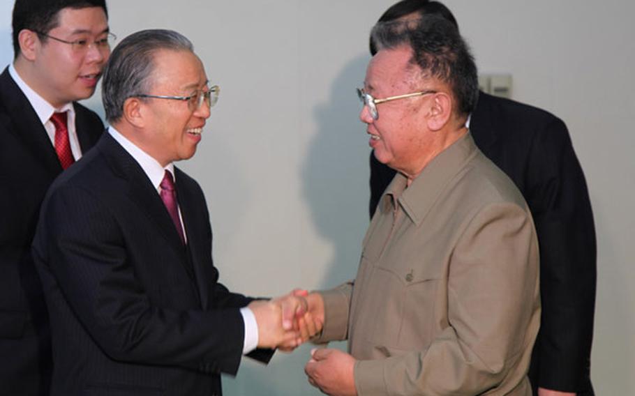 North Korean leader Kim Jong Il, right, shakes hands with Chinese State Councilor Dai Bingguo during a meeting Thursday in Pyongyang, North Korea. Although the U.S. has been pressuring China to hold talks with North Korea following a recent attack on a South Korean island, analysts say the meeting should not be viewed as China caving to those demands.