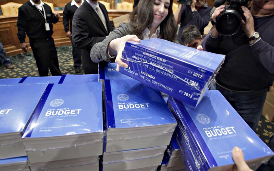 Copies of President Obamas 2012 budget are delivered to the Senate Budget Committee earlier this year. Congress and the White House are in a showdown over a massive, $662 billion defense bill.