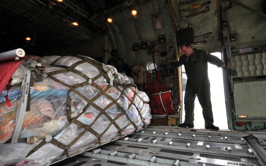 Petty Officer 1st Class Steve Doboer, a member of the U.S. Navy’s Fleet Logistics Support Squadron Sixty-Two, watches as a pallet of donated blankets is pushed out the back of his C-130 on Sunday at Misawa Air Base, Japan. Doboer and fellow squadron mates picked the gear up at Marine Corps Air Station Iwakuni, Japan, earlier in the day and brought them to Misawa as part of humanitarian relief efforts in Japanese communities devastated by a March 11 earthquake and follow-on tsunamis.

