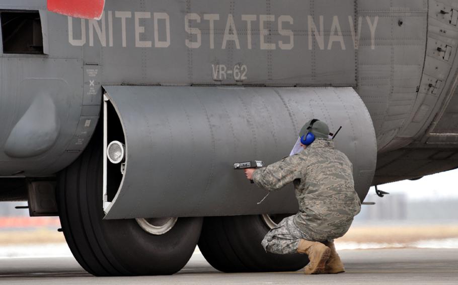 An Air Force member checks radiation levels on a Navy C-130 that brought humanitarian relief supplies to Misawa Air Base, Japan. After the plane was deemed safe, Japan Self-Defense Force members, U.S. sailors and contracted employees quickly unloaded several pallets of donated blankets and toilet paper from Marine Corps Air Station Iwakuni, Japan.
