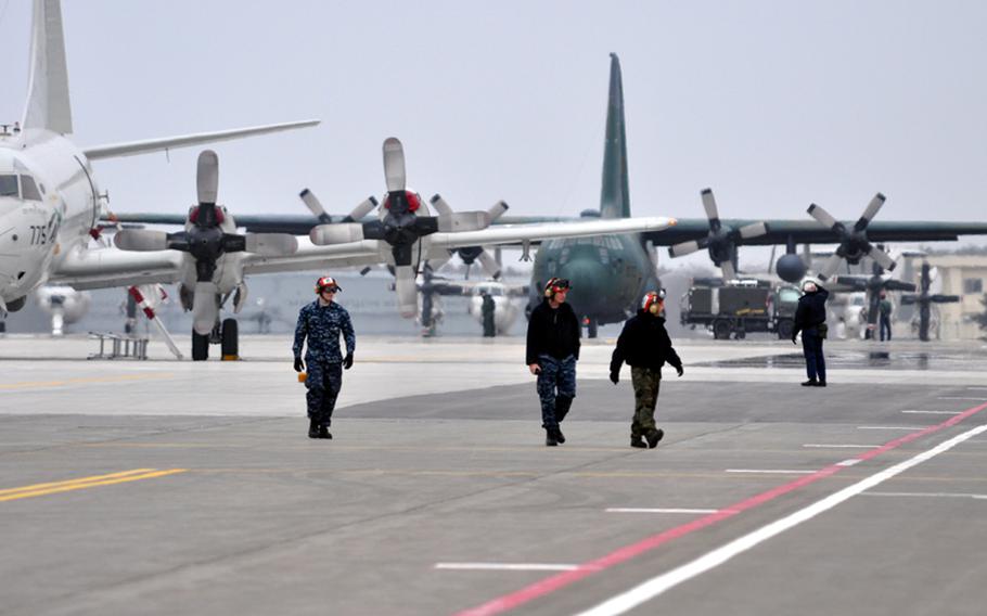 U.S. sailors walk across a busy taxi area on the flight line at Misawa Air Base, Japan, on Sunday. Hundreds of thousands of pounds of humanitarian relief supplies have been delivered to the base in response to Operation Tomodachi, a U.S. military effort aimed at assisting Japanese communities hard-hit by the March 11 earthquake and tsunamis.
